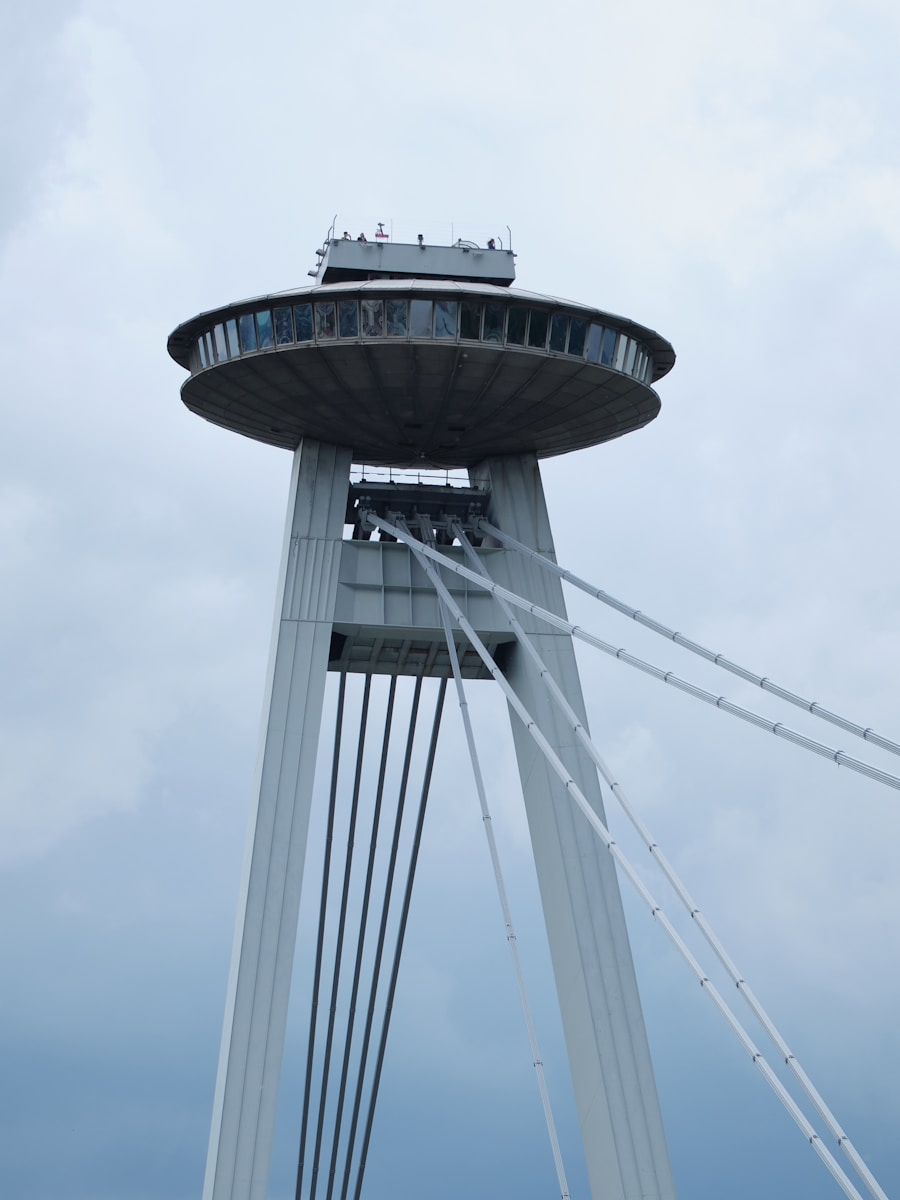 A tall white tower with a sky background